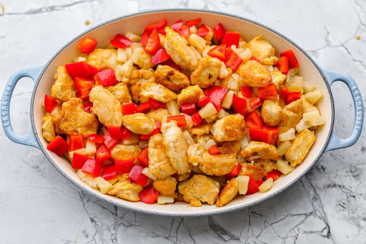Veggies and pineapple added to the baking dish with the chicken. Ready to go in the oven to be baked to perfection. 