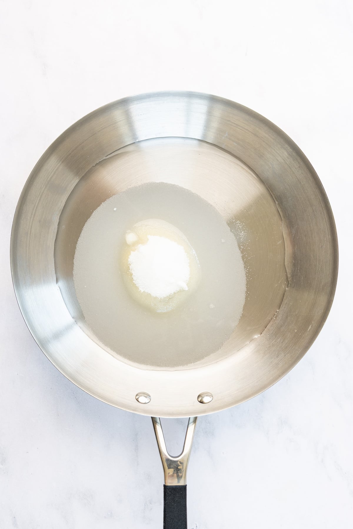 12-inch skillet with sugar and water
