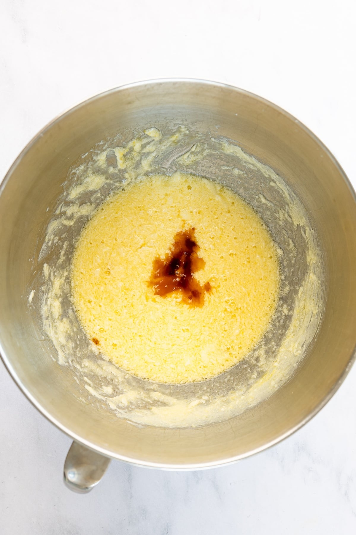 vanilla added to mixing bowl with butter/sugar/egg mixture