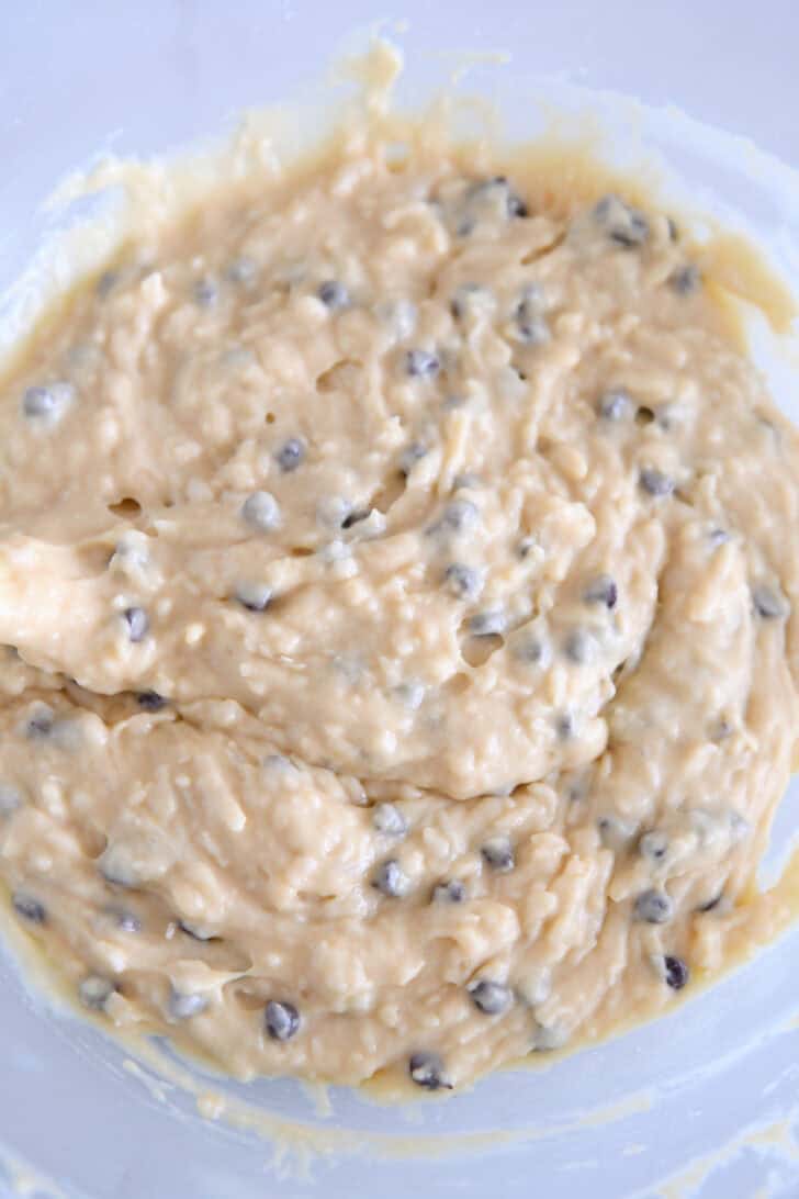 Almond coconut chocolate chip muffin batter in glass bowl.