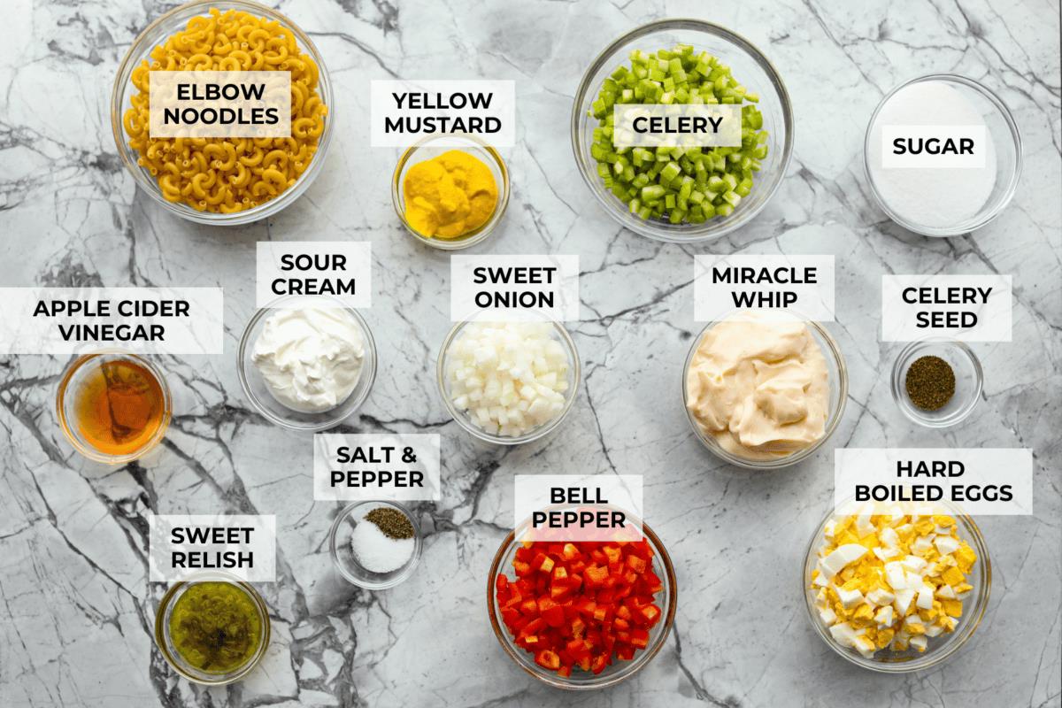 Overhead shot of labeled amish macaroni salad ingredients. 