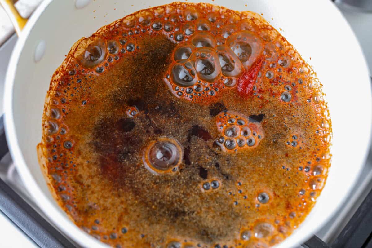 Sauce ingredients added to a pot. 