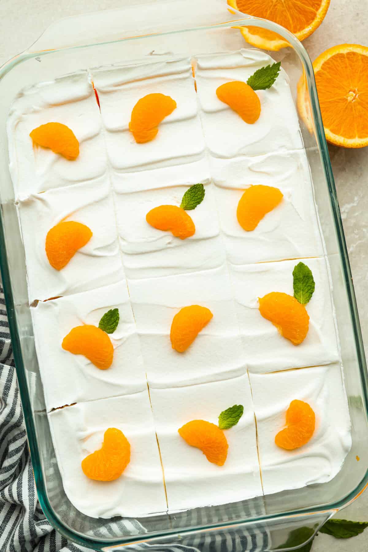 Orange creamsicle lush garnished with mandarin oranges and mint leaves. 