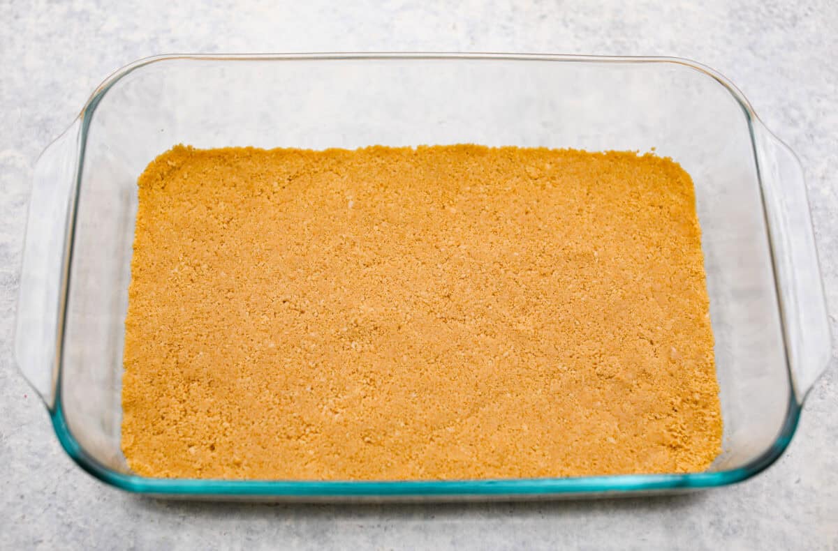 Cookie crust in the bottom of a 9x13 pan for the orange creamsicle lush dessert. 