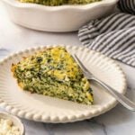 Greek spinach rice and feta pie slice on white beaded plate