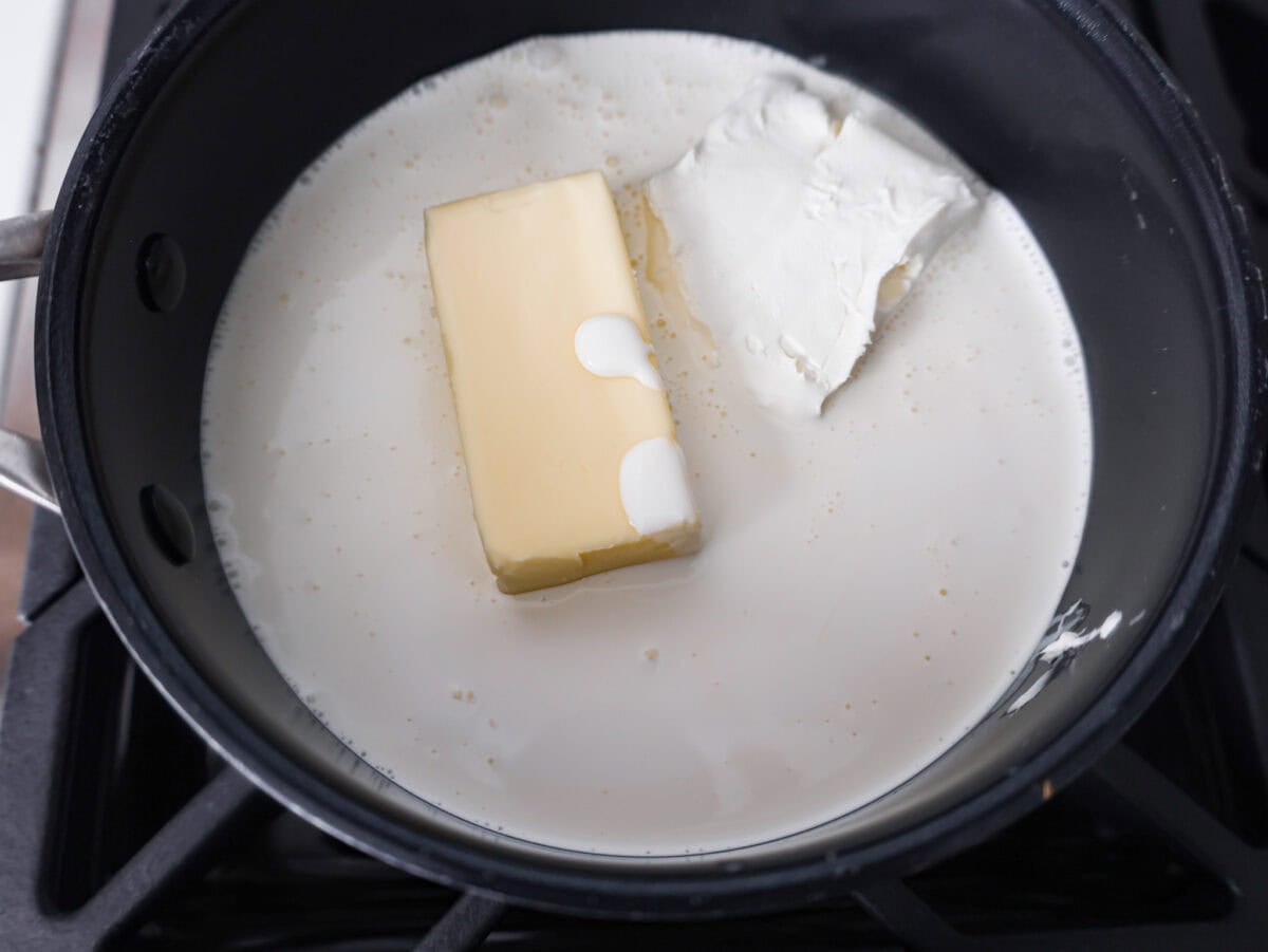 Butter, cream, and cream cheese in a pan. 