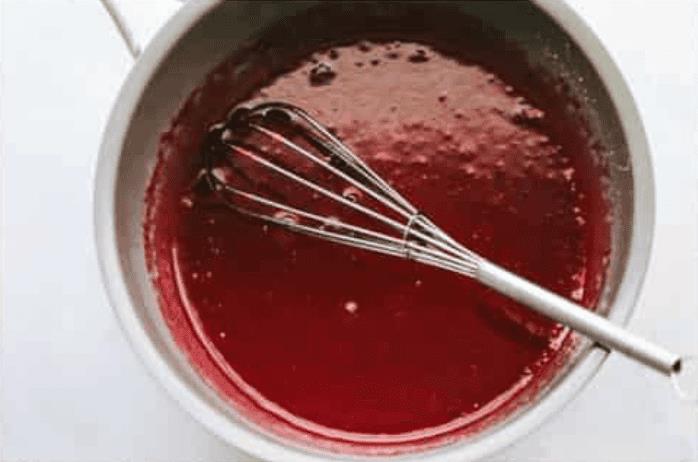 Strawberry Jell-O mixed in with the cornstarch glaze. 