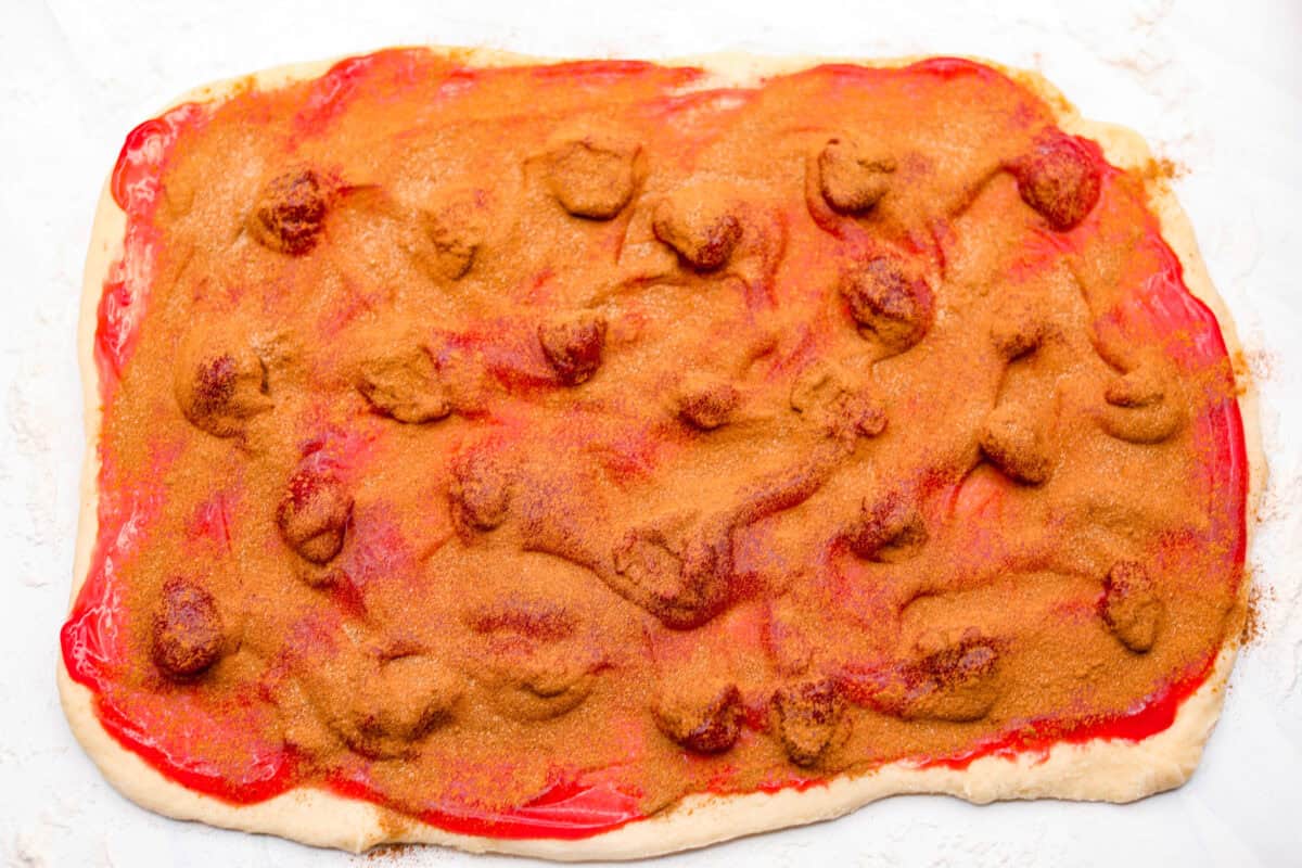 Cinnamon and sugar mixture sprinkled over the top of the strawberry pie filling that is spread on the dough. 