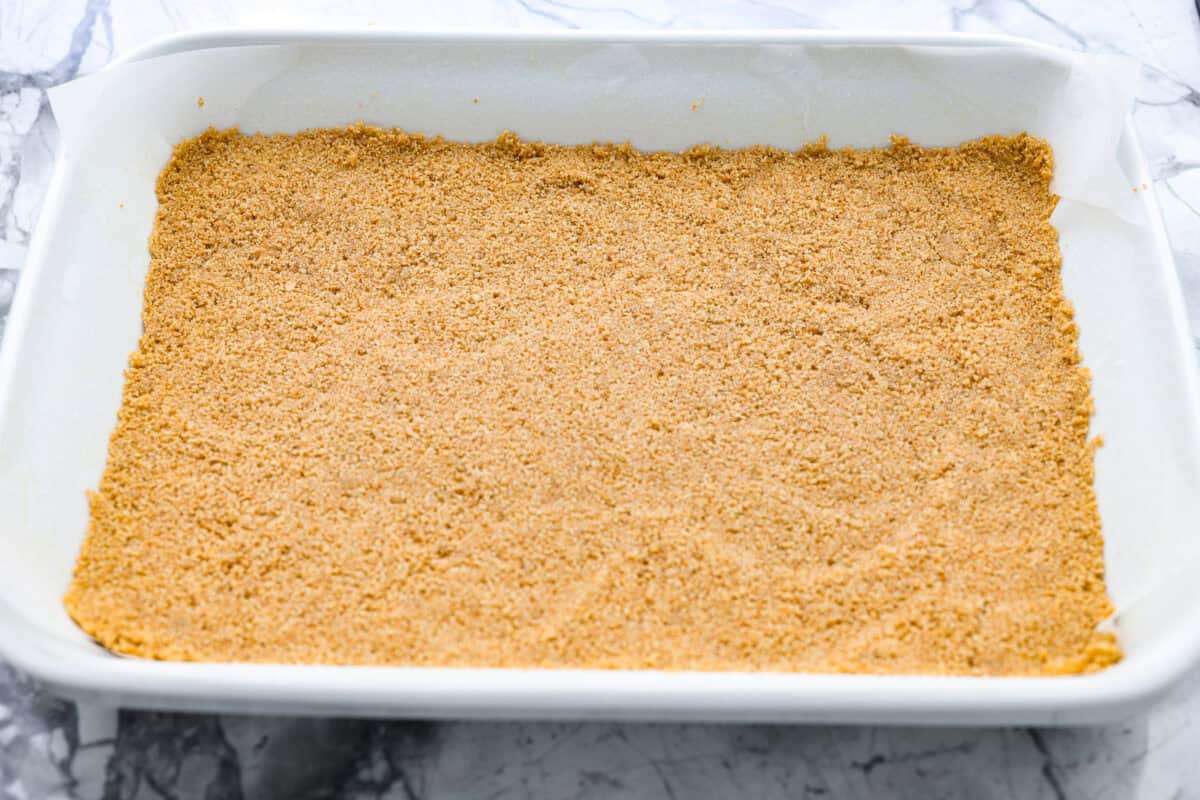 Graham crack crumbs made into a crust and smashed into the bottom of the baking dish. 