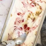 Strawberry Cheesecake Ice Cream in loaf pan with ice cream scoop