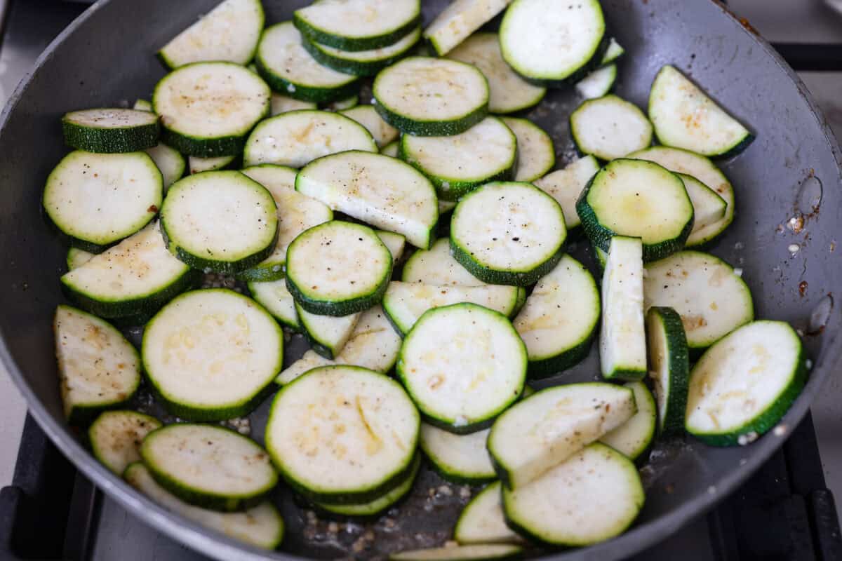 Zucchini sautéing in a skillet. 