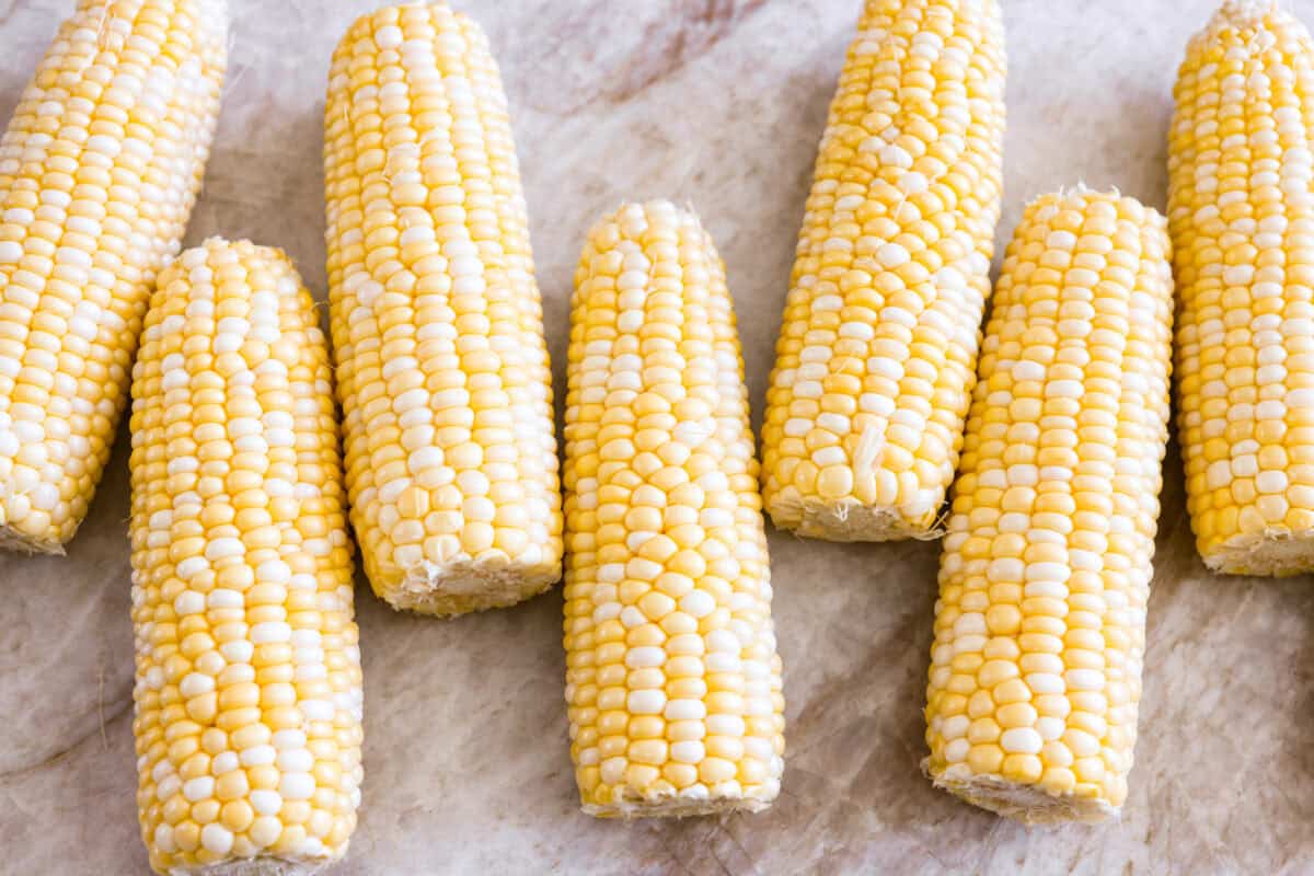 Corn cobs husked and ready to be cooked. 