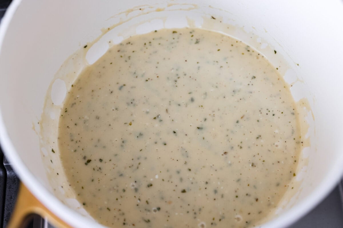 Sauce ingredients all added together in a pot on the stovetop.