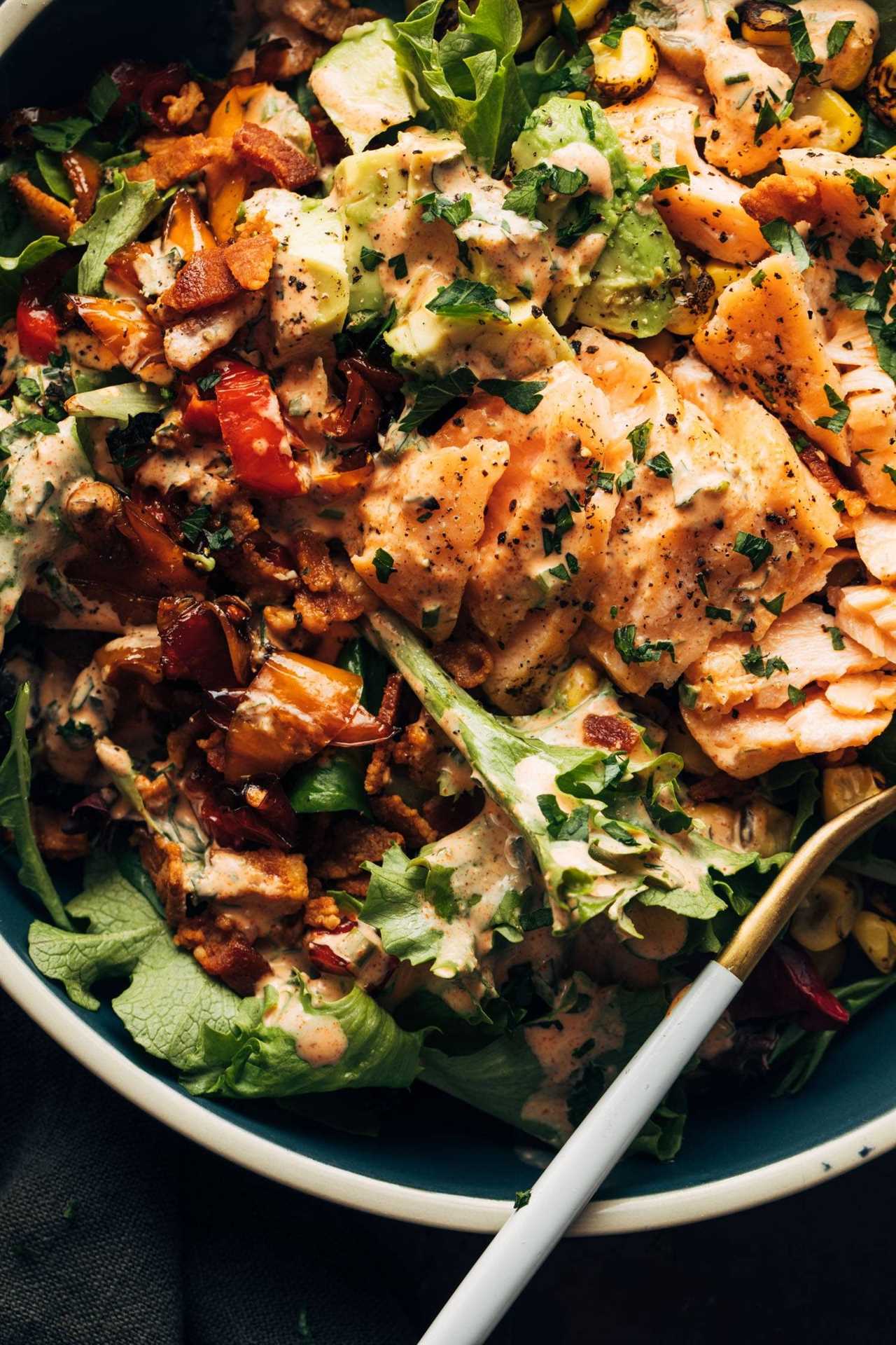 Salmon on greens with dressing.