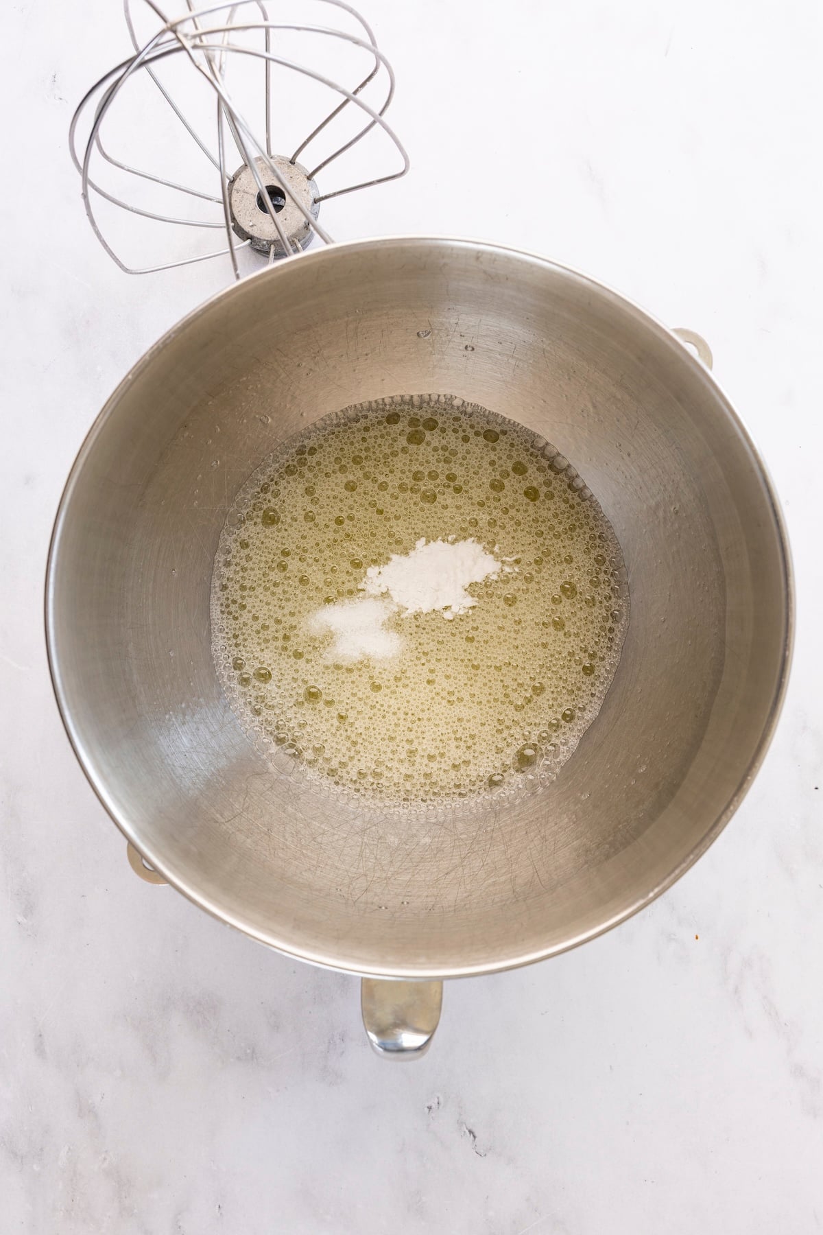 mixing bowl with cream of tartar and salt added to foamy egg whites