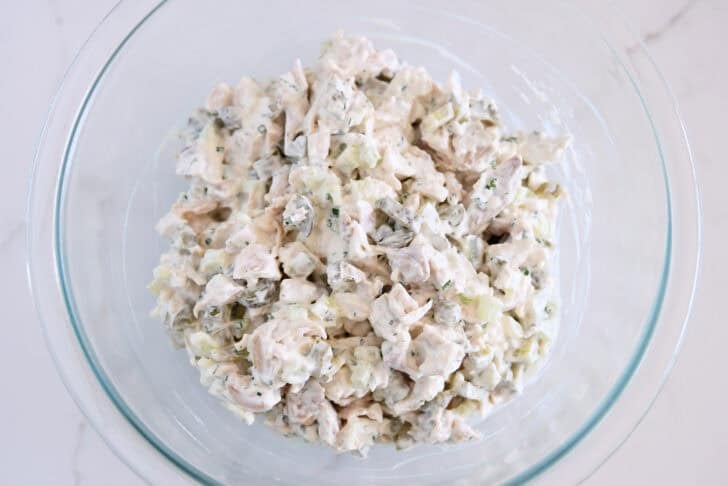 Glass bowl with creamy dill pickle chicken salad.