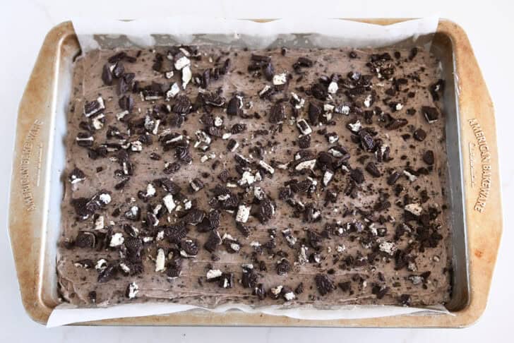 Chopped Oreo sprinkled on top of Oreo-frosted brownies.