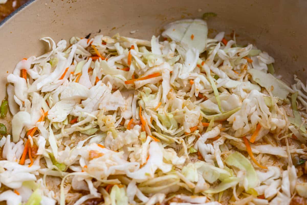 Coleslaw mix cooking in a skillet. 