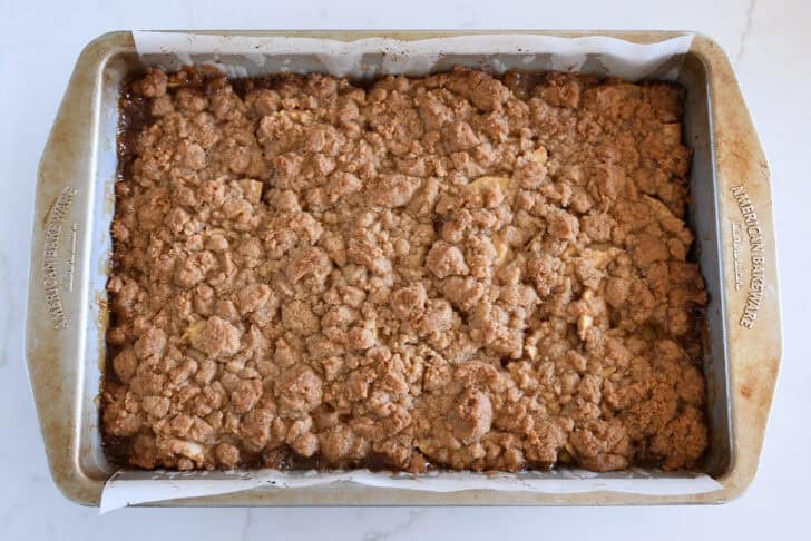 Baked metal 9X13-inch pan of caramel apple pie bars.
