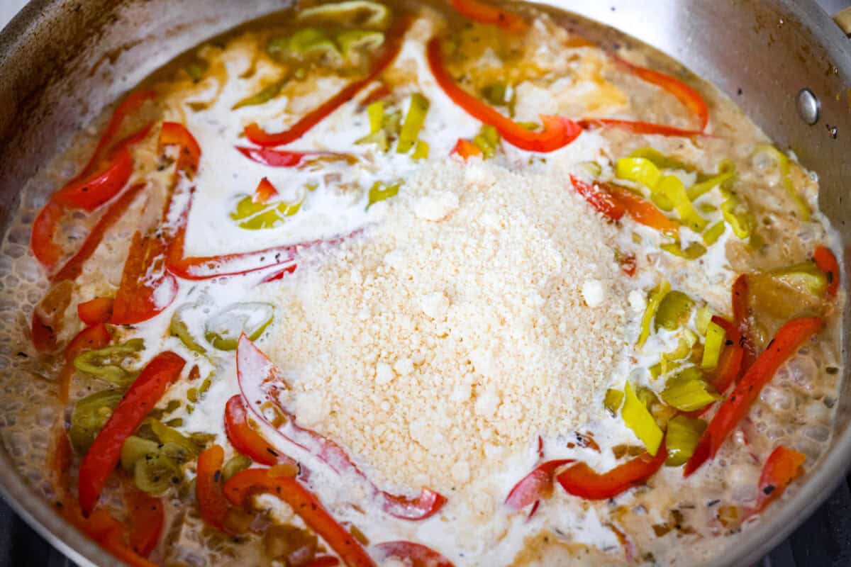 Parmesan cheese and cream added to the skillet to make the creamy pepperoncini chicken sauce. 