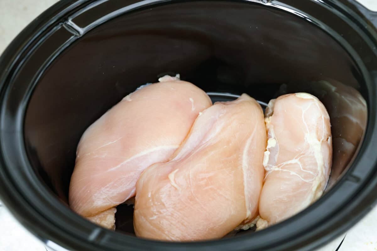 Chicken breasts added to the bottom of the crockpot. 