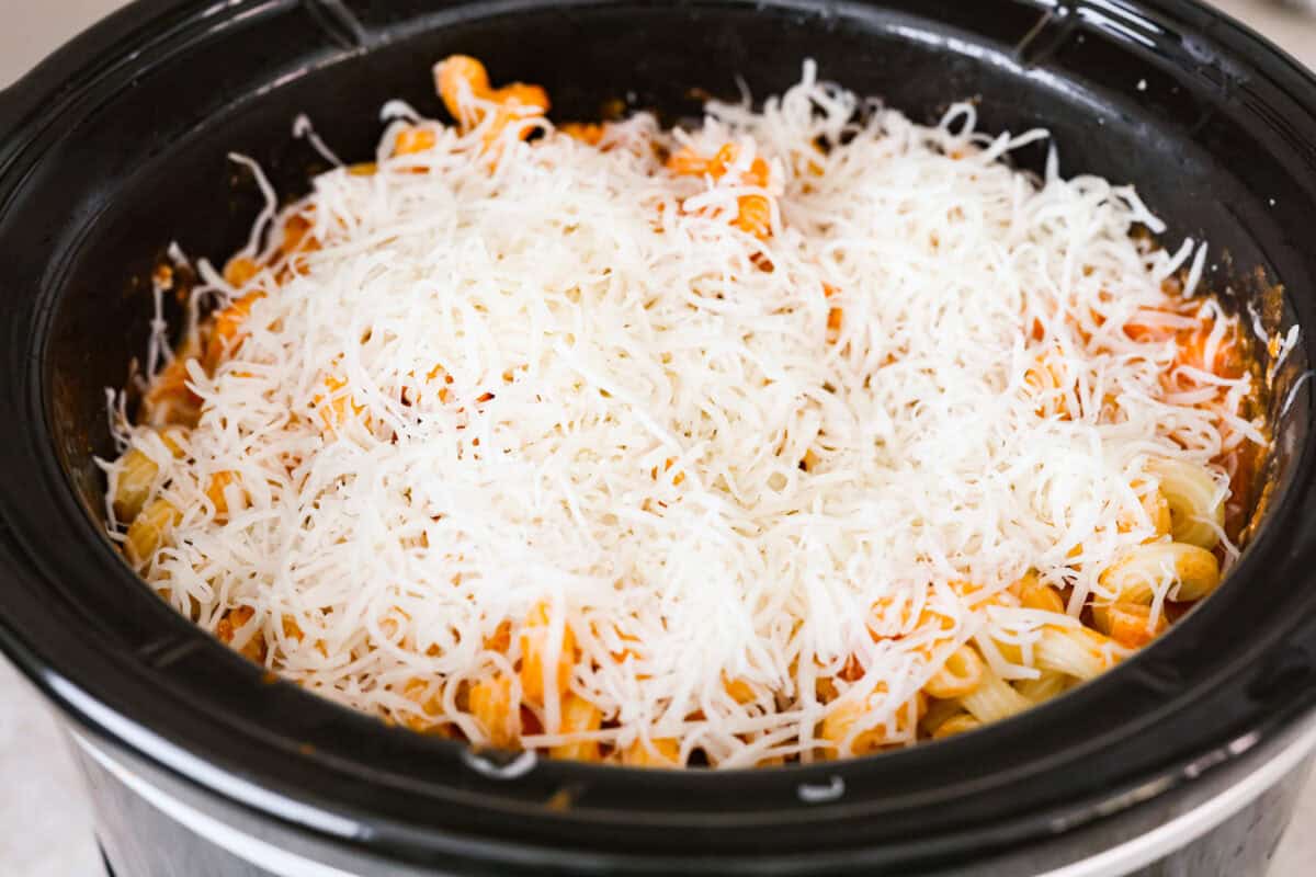 Cheese added to the top of the ingredients in the crockpot. 