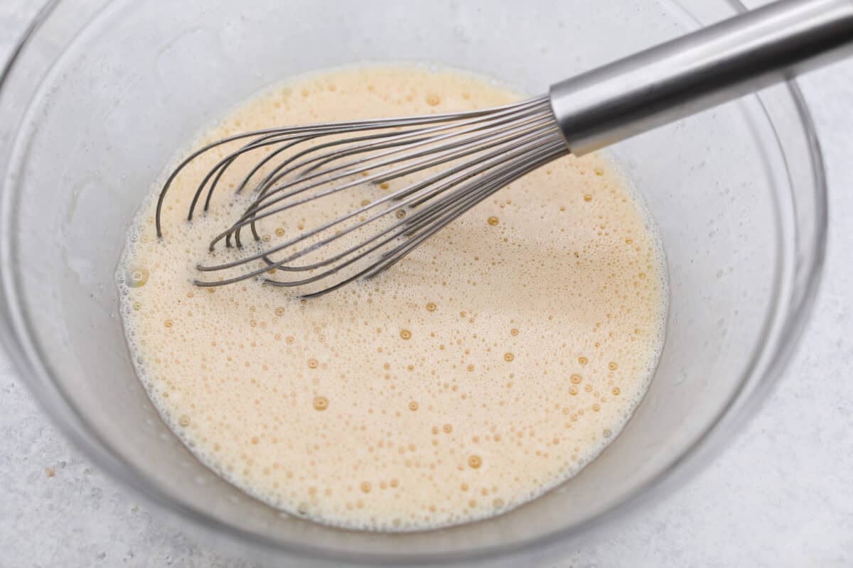 Wet ingredients whisked together in a mixing bowl. 