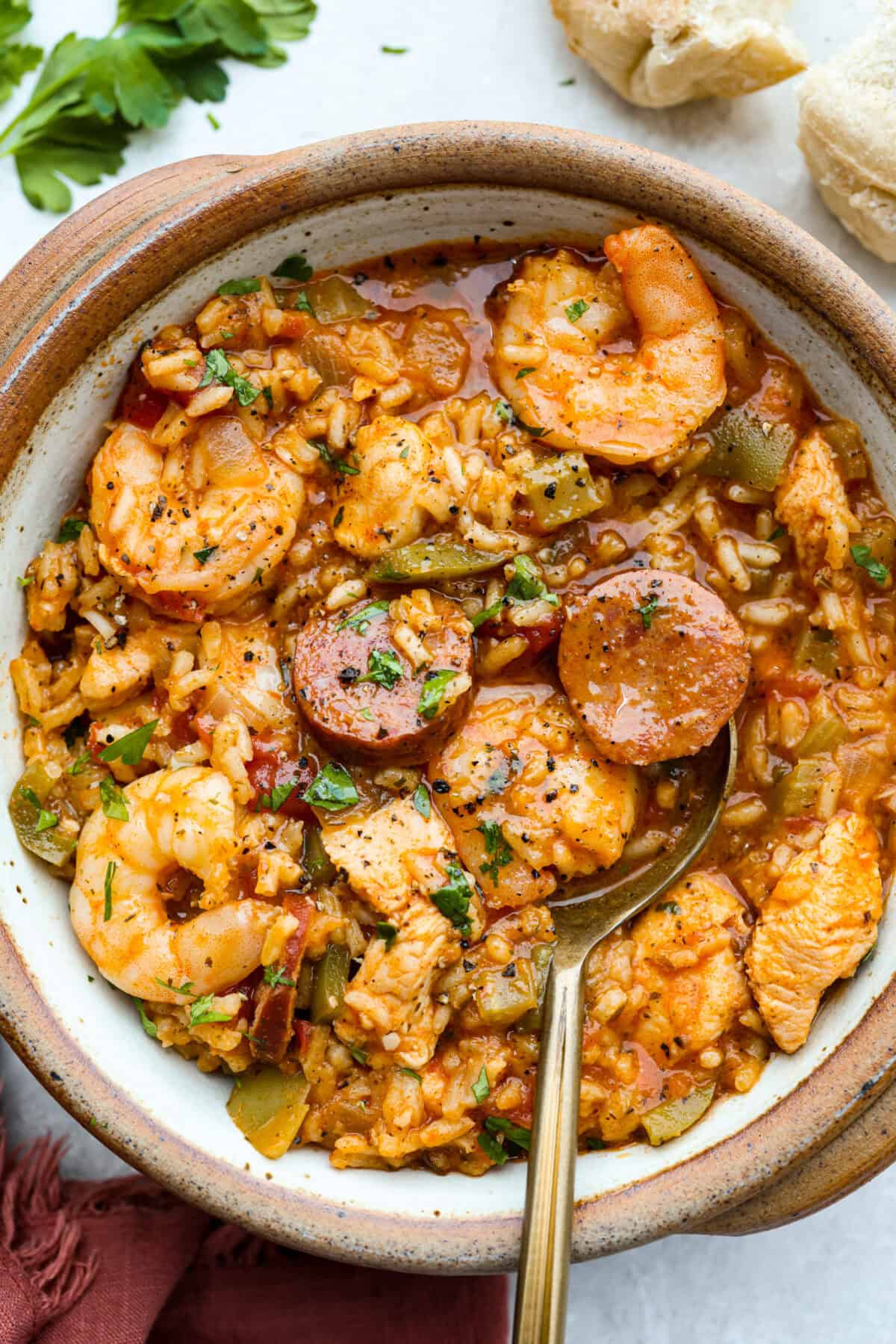 Bowl of classic jambalaya with a gold spoon. 