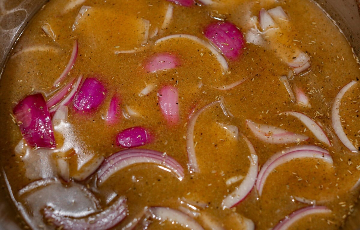 Apple cider, chicken broth, mustard and spices added to the garlic and onions. 
