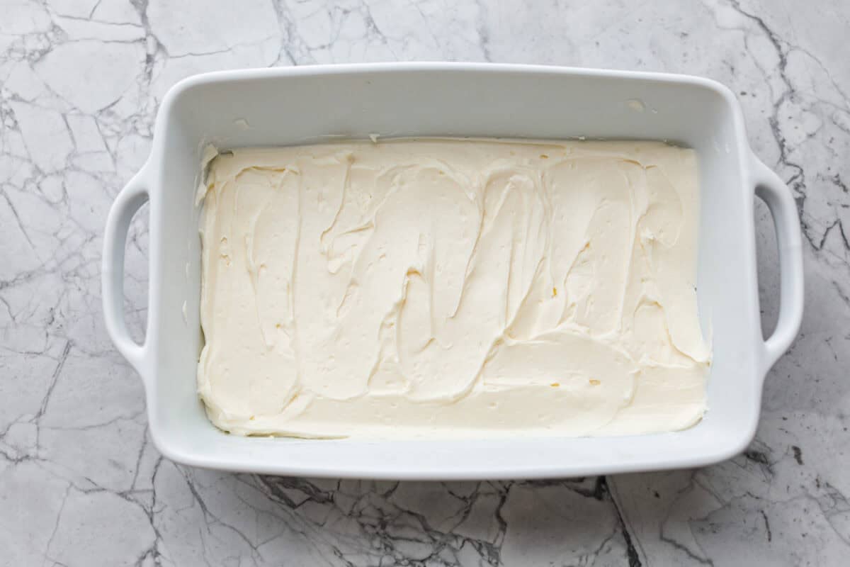 Cream cheese spread into the bottom of the baking dish. 