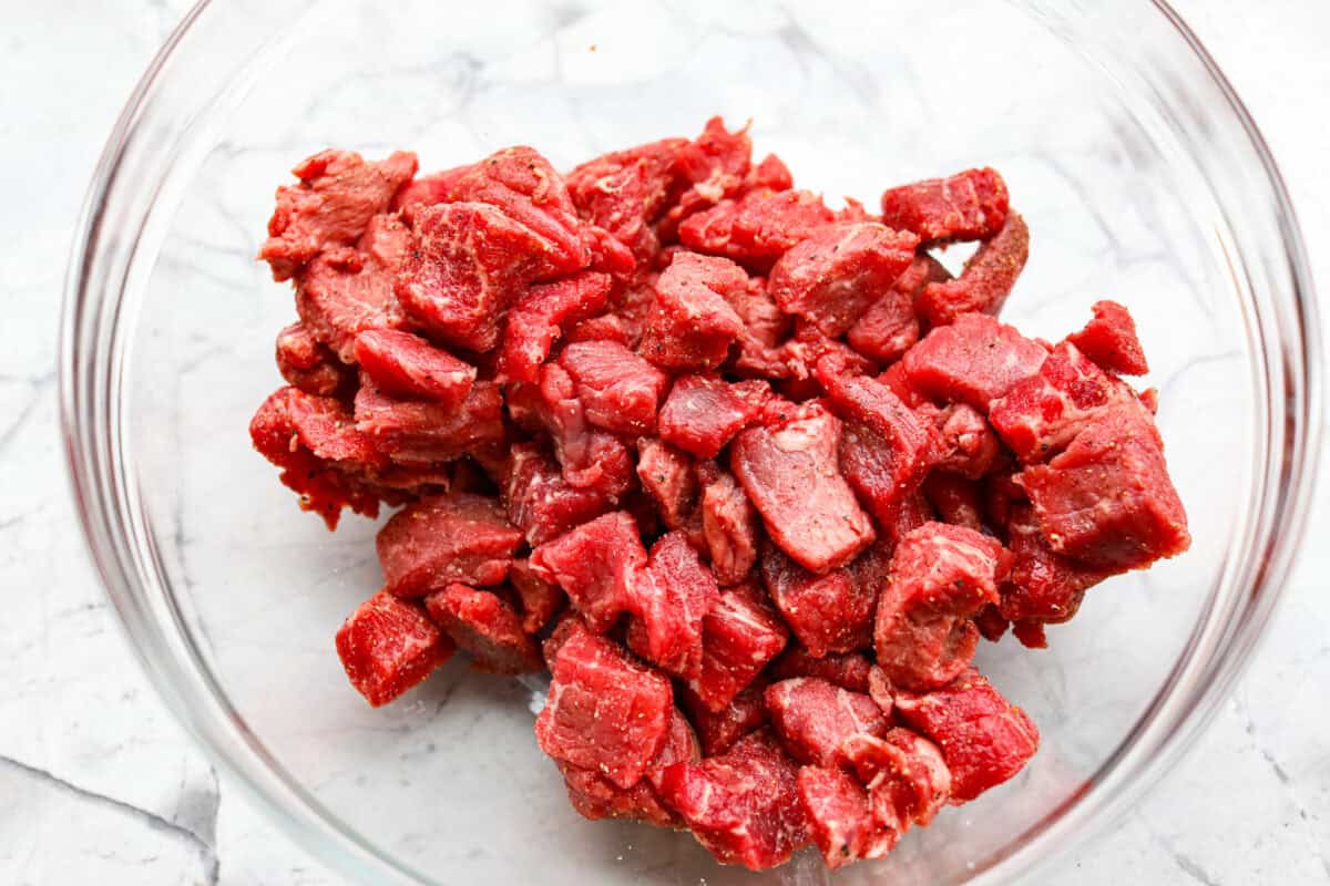Seasoned beef in a glass bowl. 
