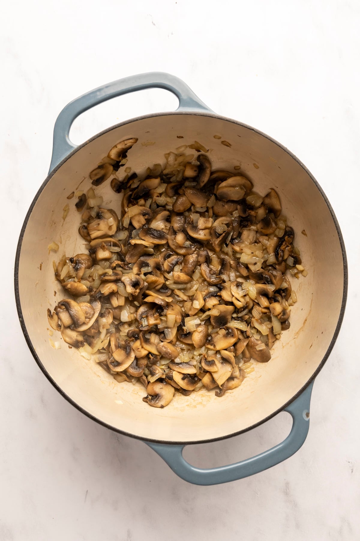 dutch oven with cooked mushrooms and onions