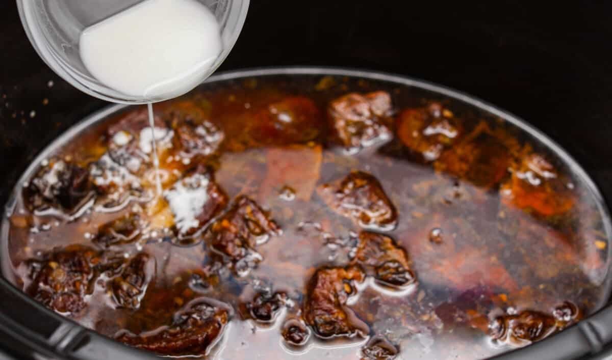 Cornstarch slurry added to the slow cooker to thicken the sauce. 