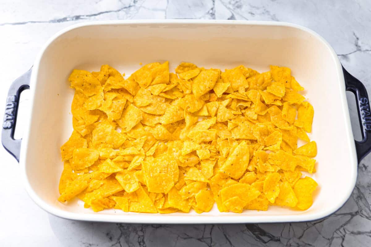 Tortilla chips added to the bottom of the baking dish. 
