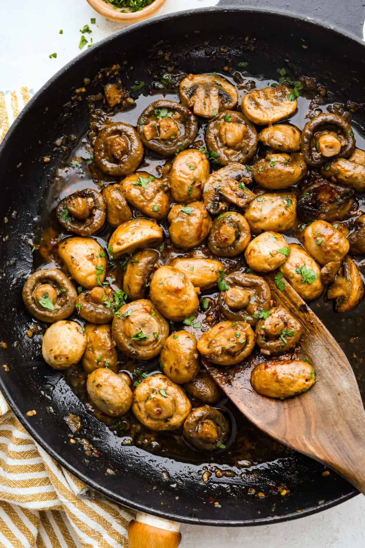 Skillet with tender cowboy mushrooms covered in butter, cooked and ready to devour. 