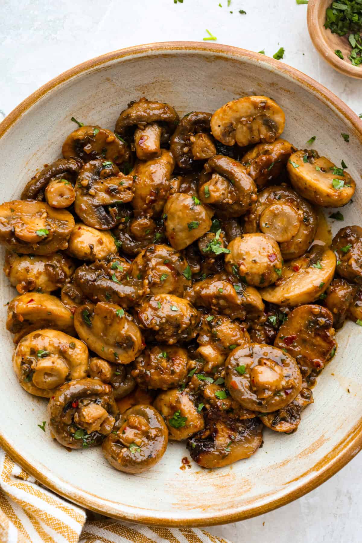 Bowl of cowboy mushrooms soaking in delicious seasoned butter. 